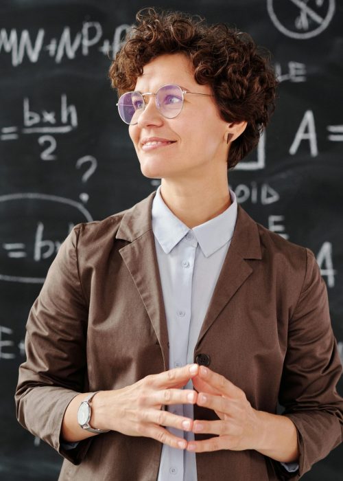 Photo of a teacher with short hair and a brown blazer